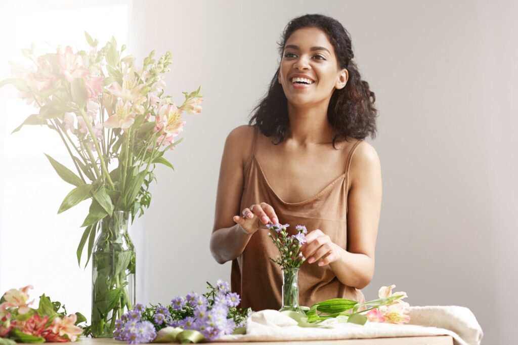 beautiful-cheerful-african-woman-florist-smiling-making