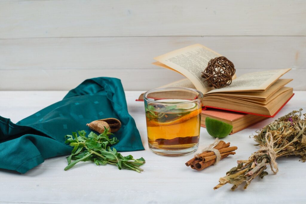 close-up-herbal-tea-flowers-with-books-lemon-spices-gree