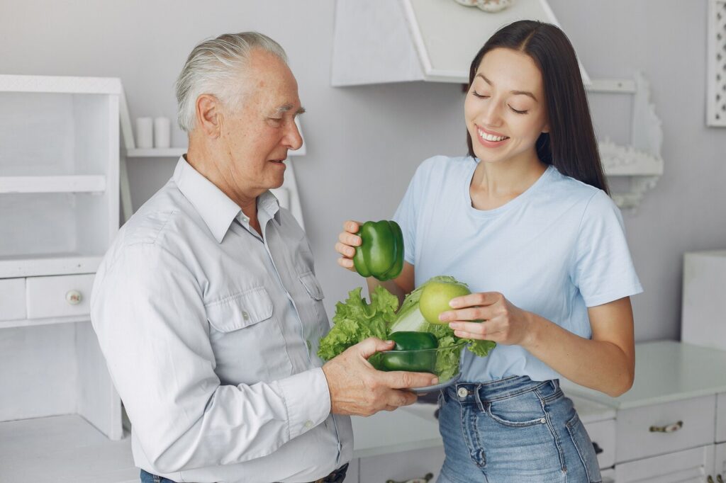 old-man-kitchen-with-young-granddaughter