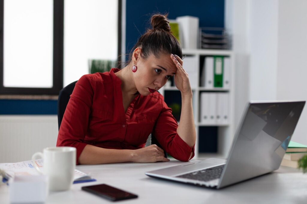 tired-businesswoman-sitting-startup-business-desk-looking-laptop