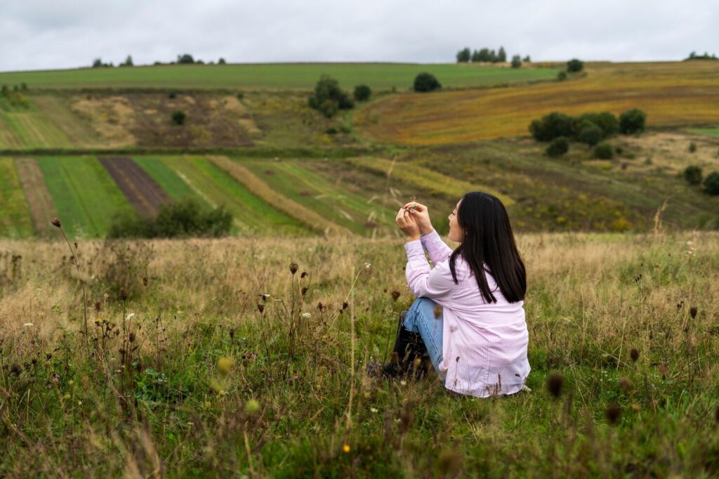 woman-sitting-outdoors-full-shot